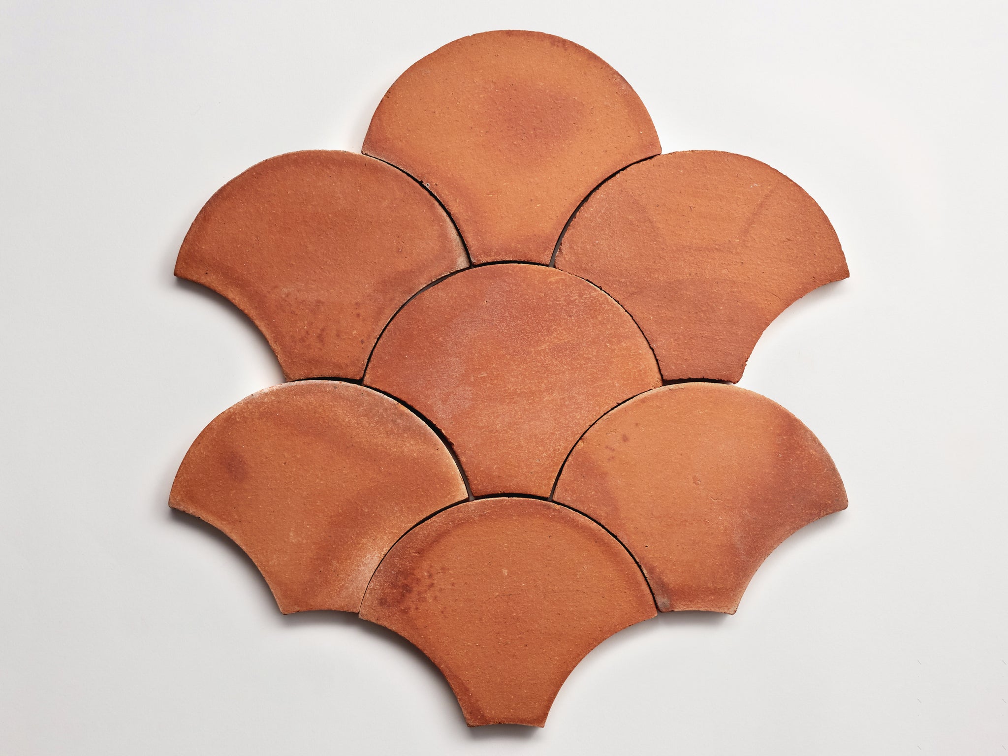 a set of red clay tiles on a white background.